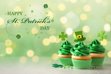 Image of Delicious decorated cupcakes on light table. St. Patrick's Day celebration