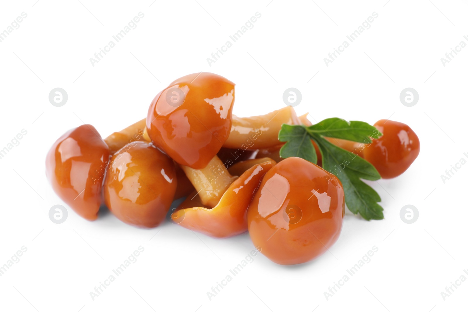 Photo of Tasty marinated honey fungus mushrooms with parsley on white background