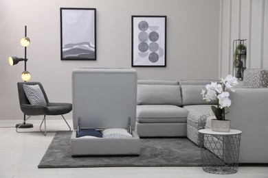 Open section with storage near modular sofa in living room. Interior design