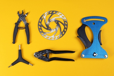 Set of different bicycle tools and part on color background, flat lay
