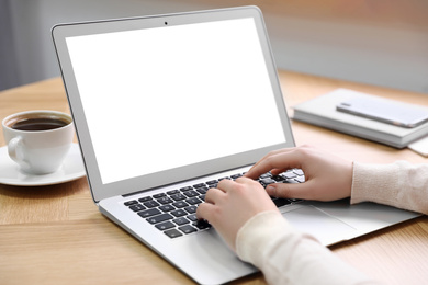 Young woman using modern computer at table in office, closeup. Space for design