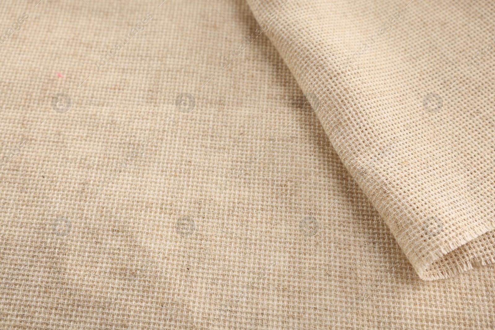 Photo of Texture of natural burlap fabric as background, closeup