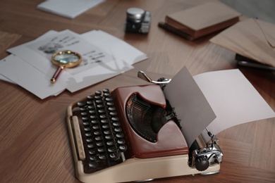 Photo of Typewriter, fingerprints and papers on desk. Detective's workplace