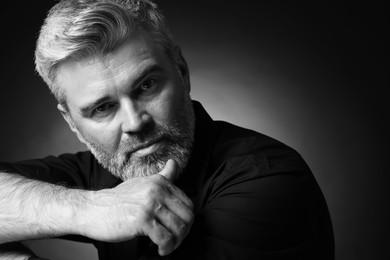 Portrait of handsome man on dark background. Black and white effect