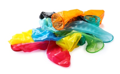Image of Pile of unrolled bright condoms on white background. Safe sex