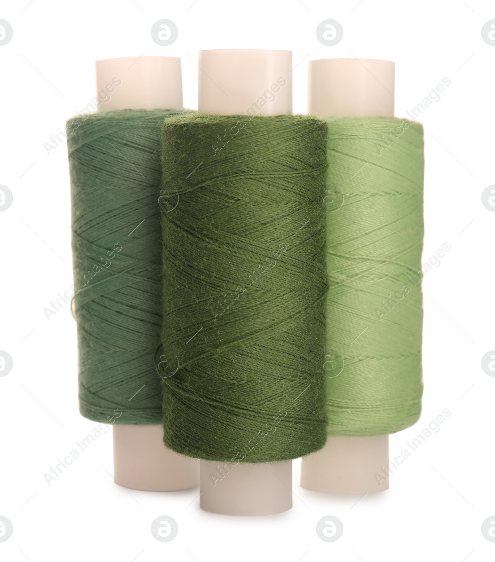 Photo of Different colorful sewing threads on white background