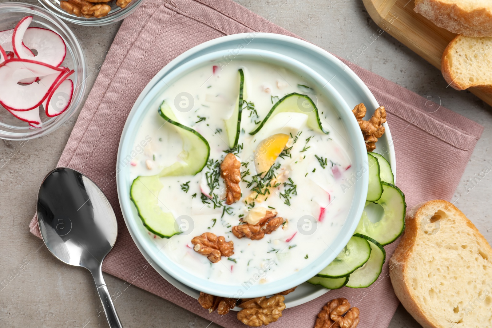 Photo of Delicious cold summer soup on grey table, flat lay