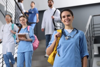 Photo of Portrait of medical student with stethoscope on staircase in college, space for text