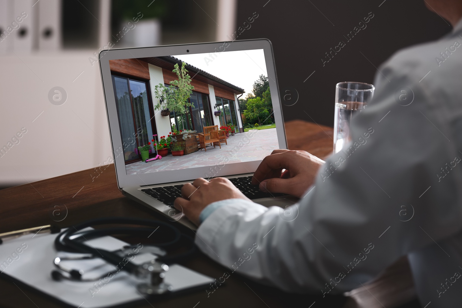 Image of Real estate agency online service. Doctor choosing new house via laptop, closeup