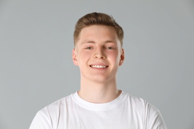 Photo of Portrait of teenage boy on light grey background