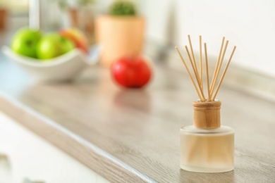 Photo of Aromatic reed freshener on table indoors