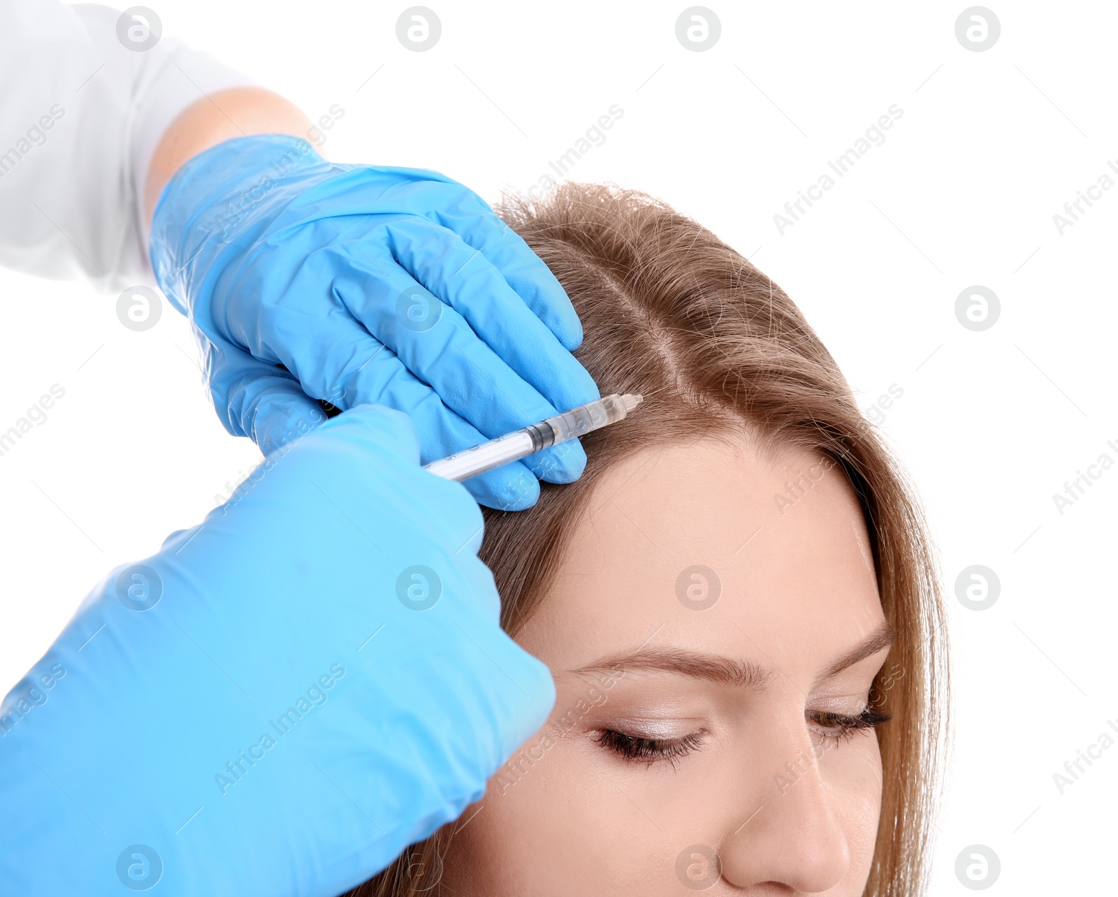 Photo of Young woman with hair loss problem receiving injection on white background