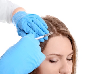 Photo of Young woman with hair loss problem receiving injection on white background