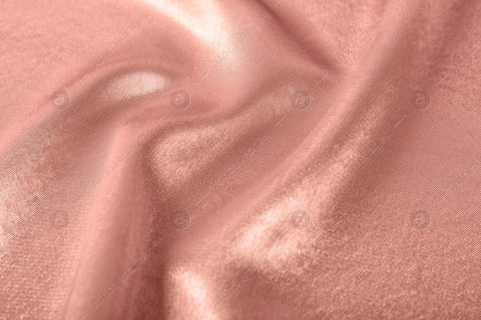 Photo of Texture of rose gold silk as background, closeup