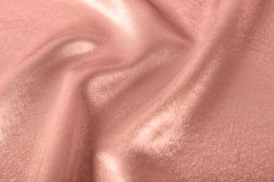 Texture of rose gold silk as background, closeup