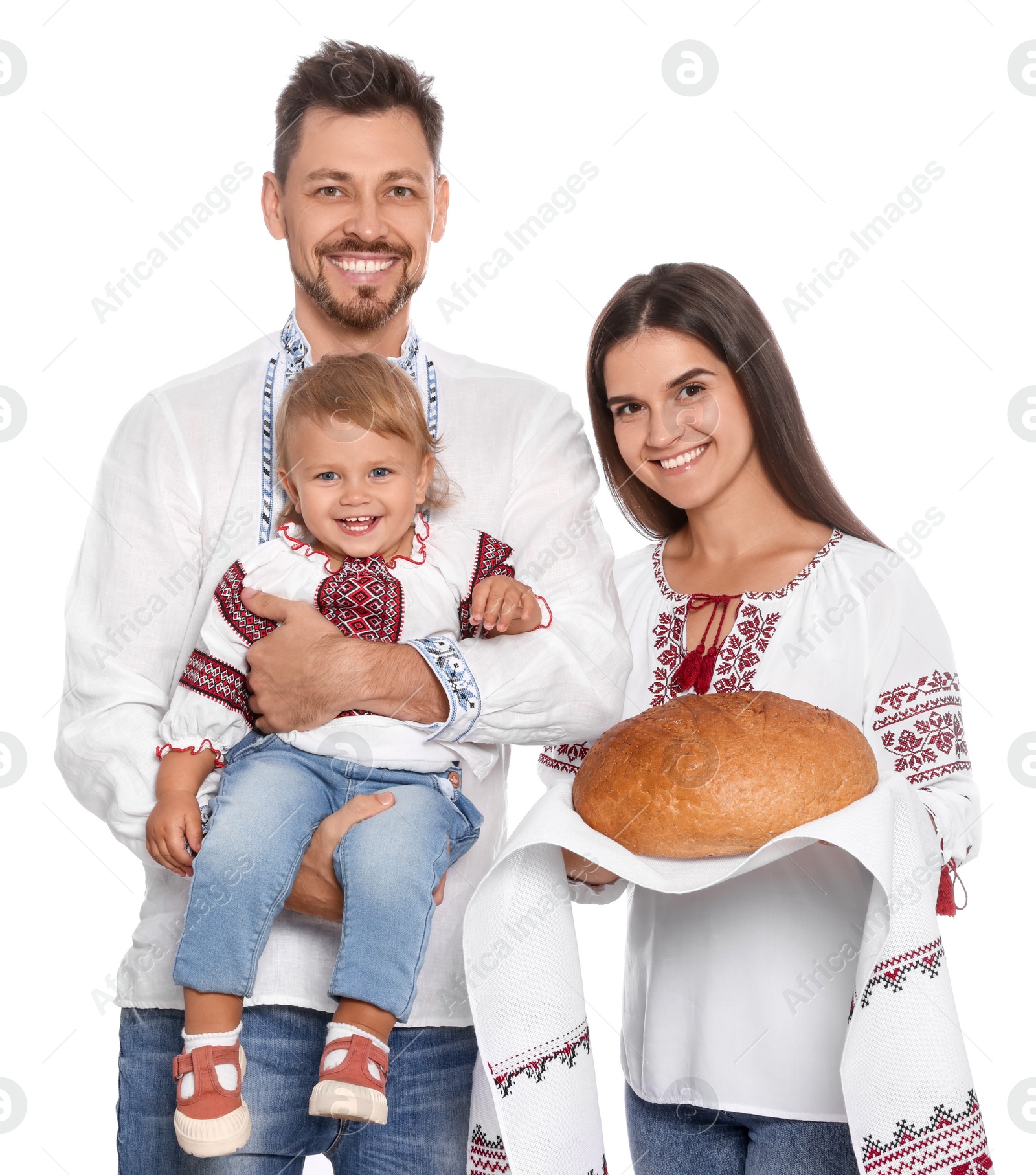 Photo of Happy Ukrainian family in embroidered shirts with korovai bread on white background