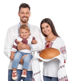Happy Ukrainian family in embroidered shirts with korovai bread on white background