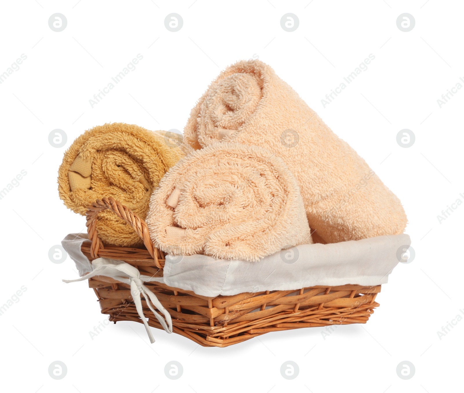 Photo of Wicker basket with rolled bath towels isolated on white