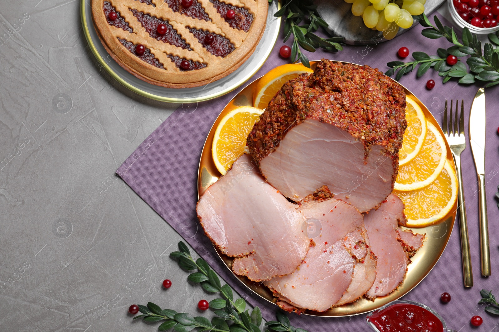 Photo of Flat lay composition with delicious ham for Christmas dinner on grey table