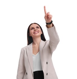 Beautiful businesswoman in suit pointing at something on white background, low angle view