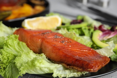 Tasty cooked salmon and fresh salad on plate, closeup. Healthy meals from air fryer