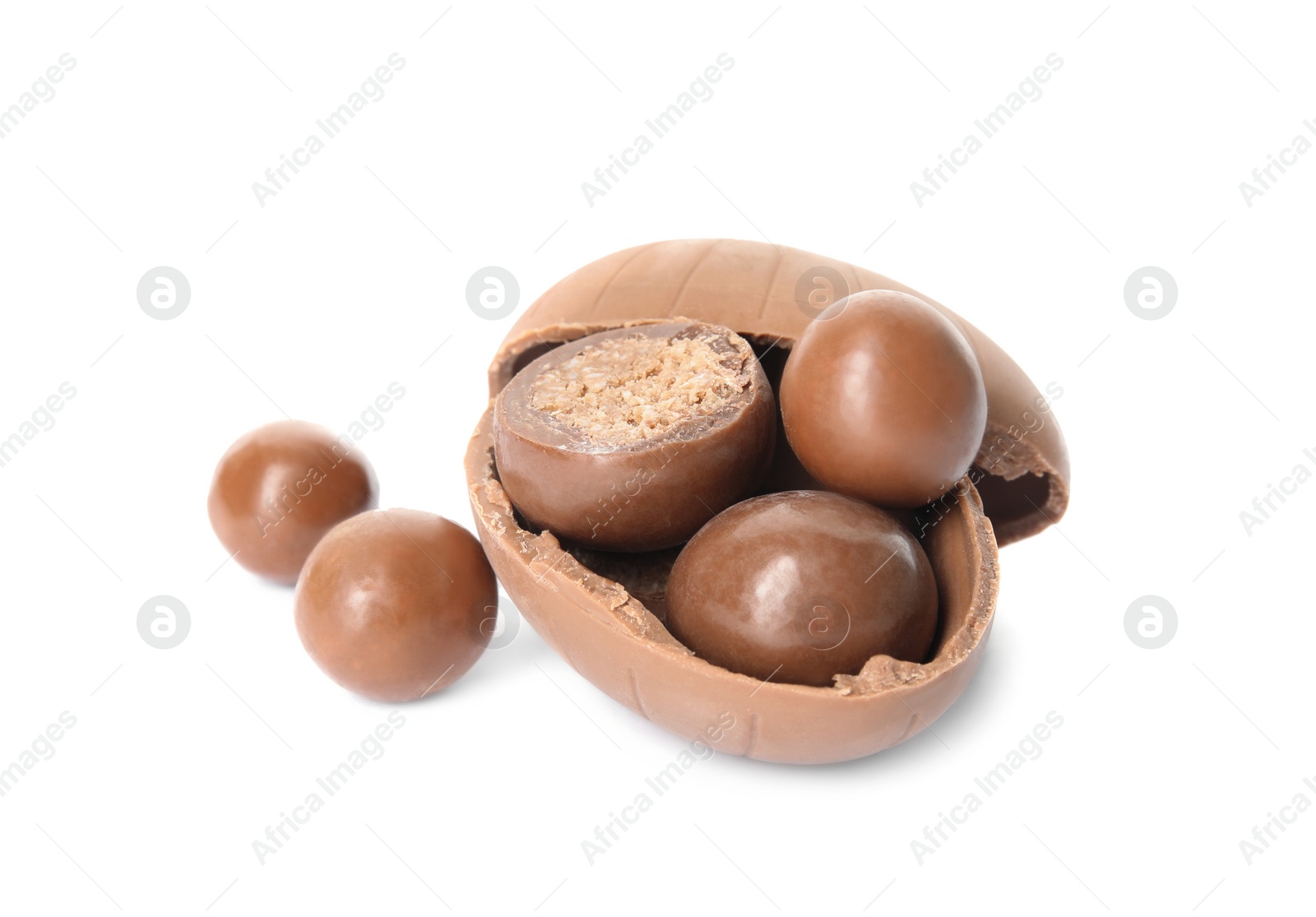 Photo of Broken chocolate Easter egg with candies on white background