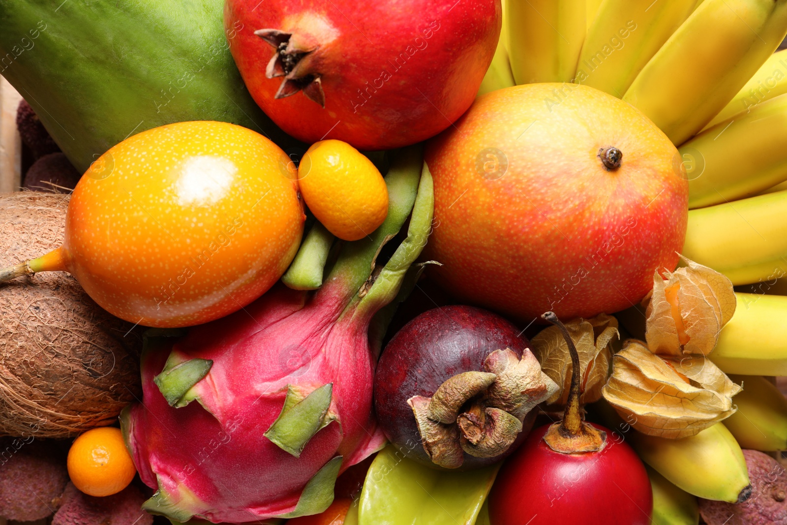 Photo of Different delicious exotic fruits as background, top view