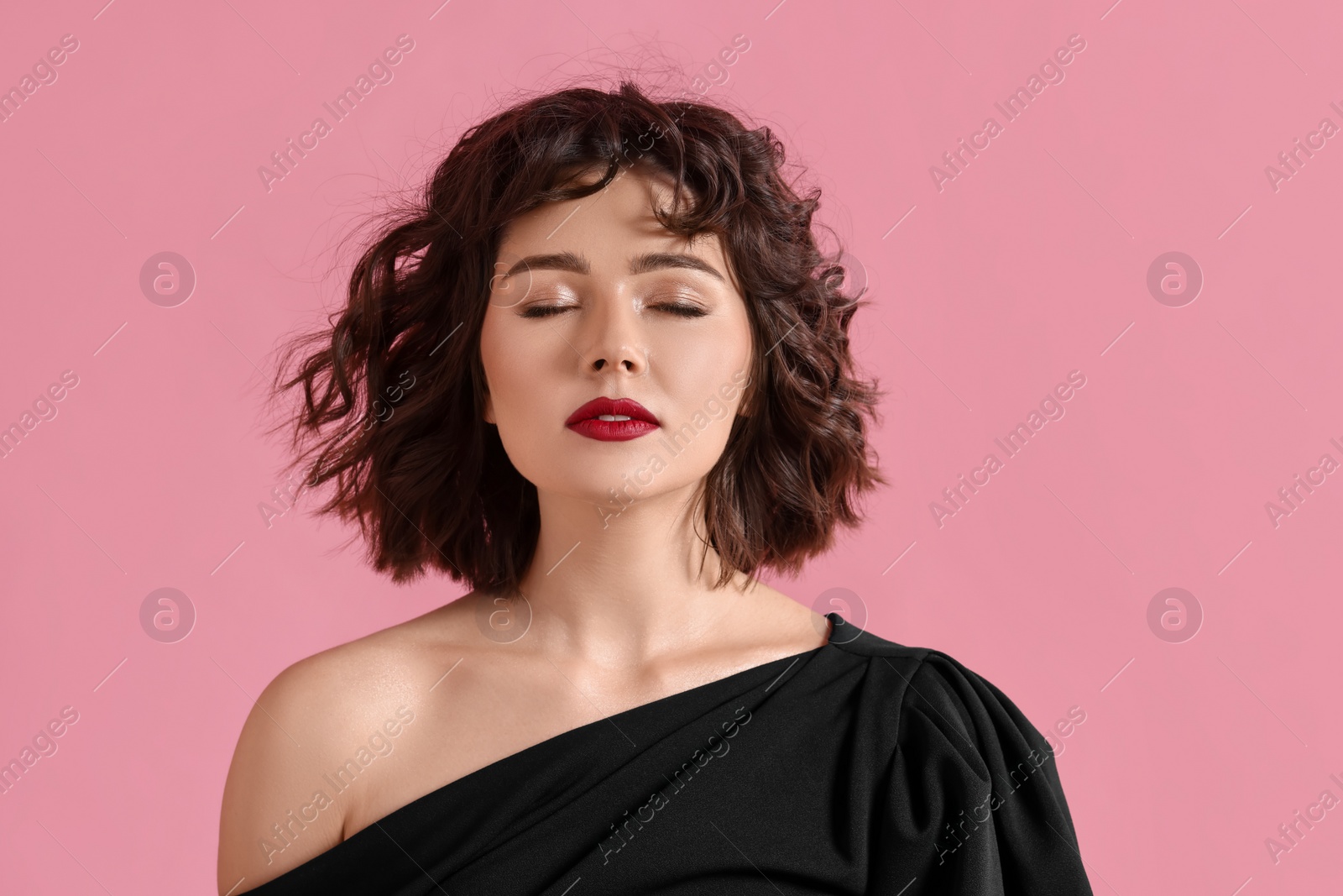 Photo of Portrait of beautiful young woman with wavy hairstyle on pink background. Space for text