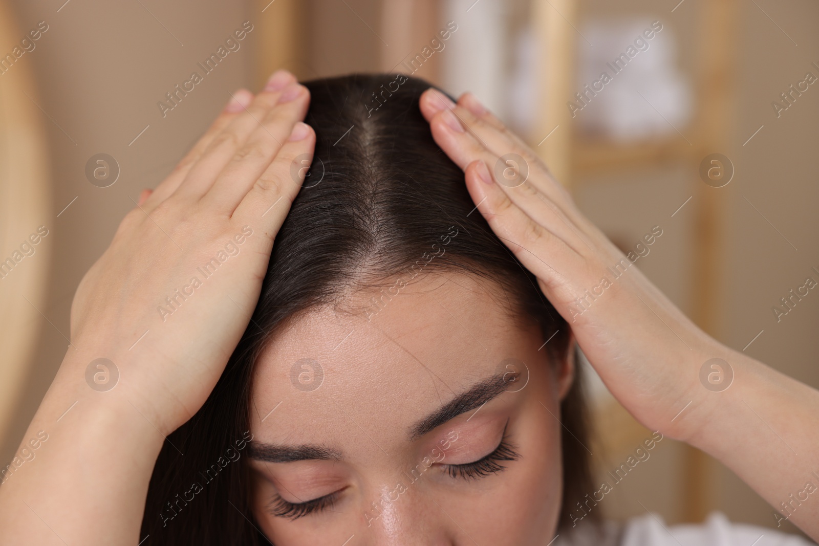 Photo of Woman examining her hair and scalp on blurred background, closeup