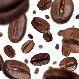 Image of Roasted coffee beans falling o white background