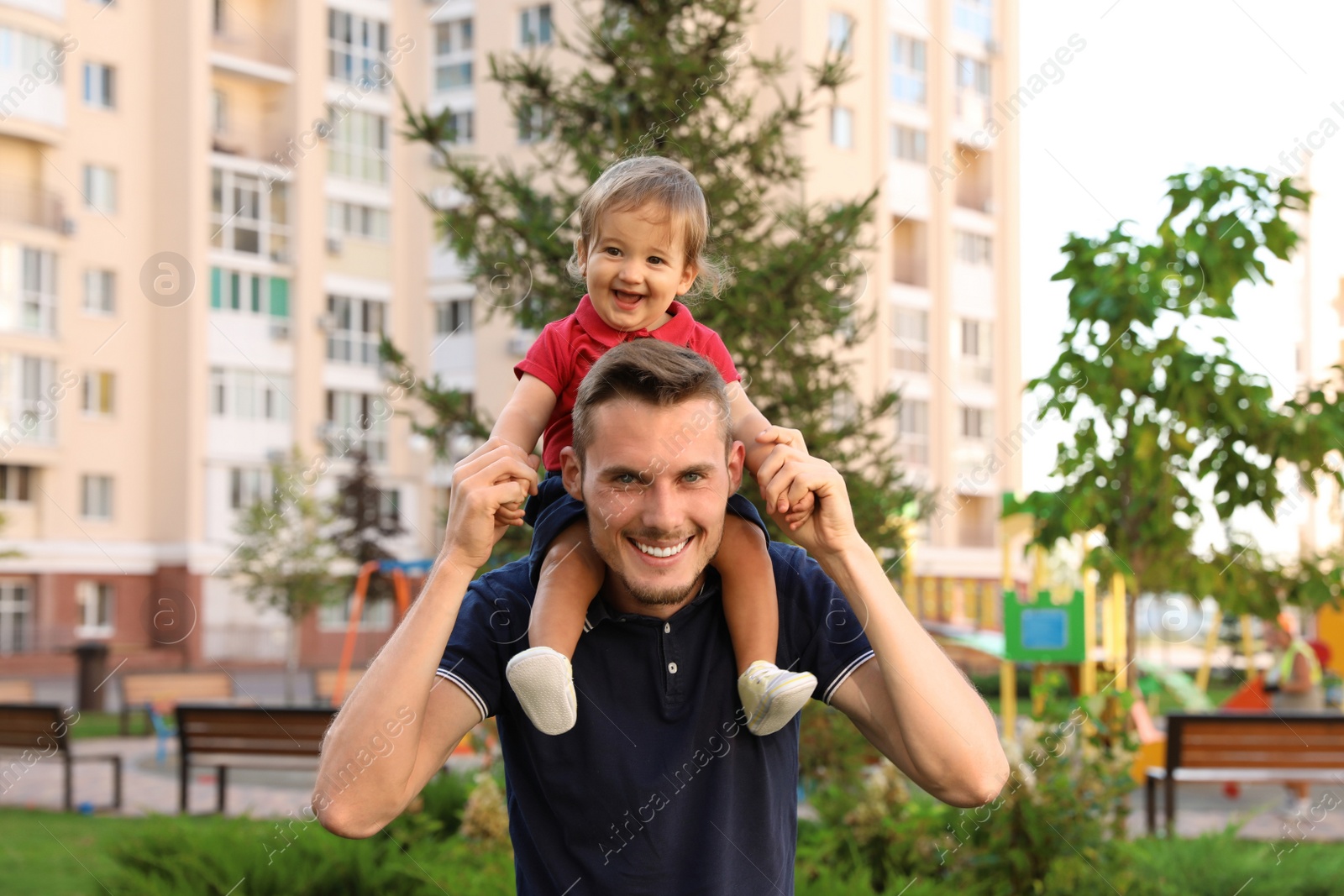 Photo of Father with adorable little baby outdoors. Happy family