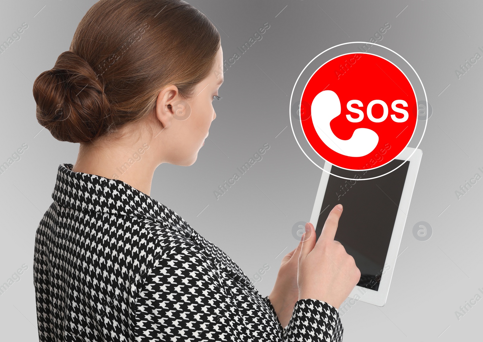 Image of Young woman with tablet and virtual icon SOS on grey background