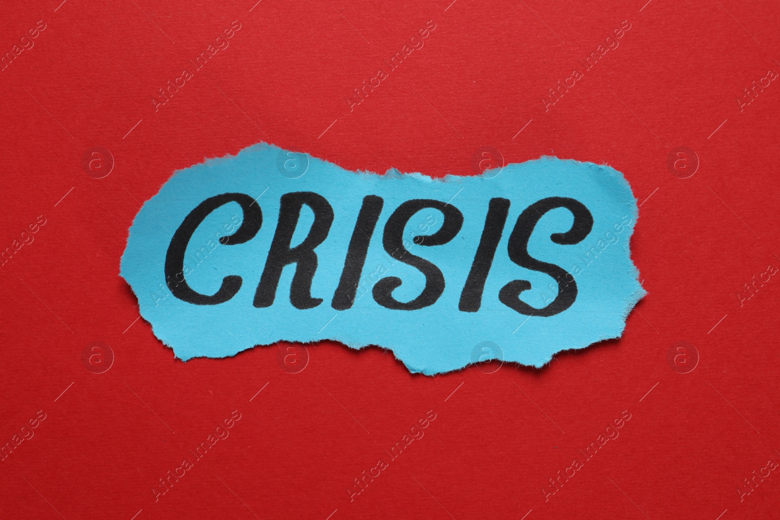 Photo of Piece of paper with word Crisis on red background, closeup