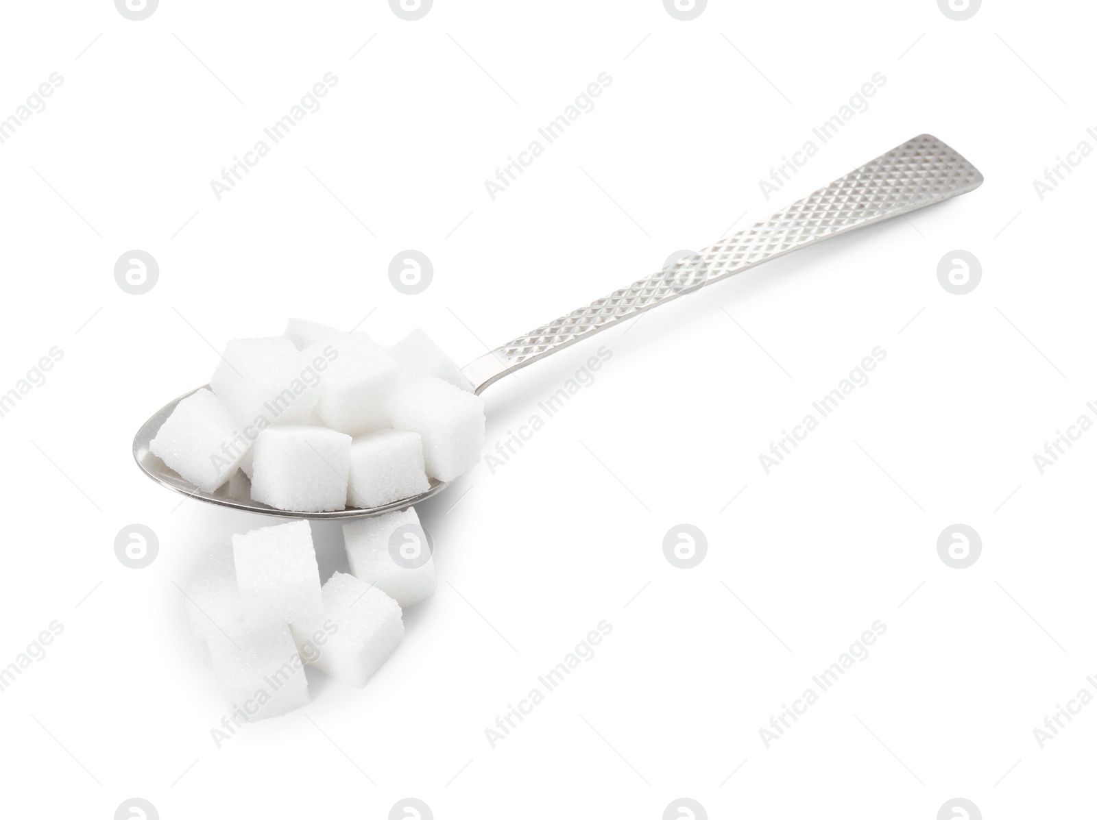 Photo of Sugar cubes and metal spoon isolated on white