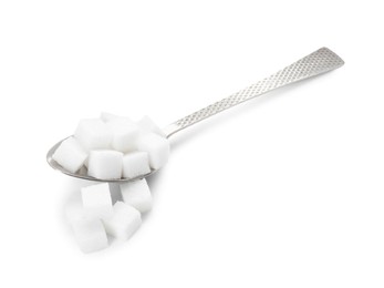 Sugar cubes and metal spoon isolated on white