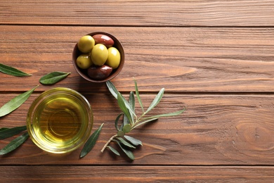 Photo of Flat lay composition with fresh olive oil on wooden background