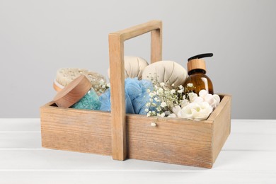 Photo of Spa gift set with different products in crate on white wooden table