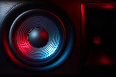 Photo of One sound speaker in neon light as background, closeup