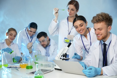 Group of scientists working in modern chemistry laboratory