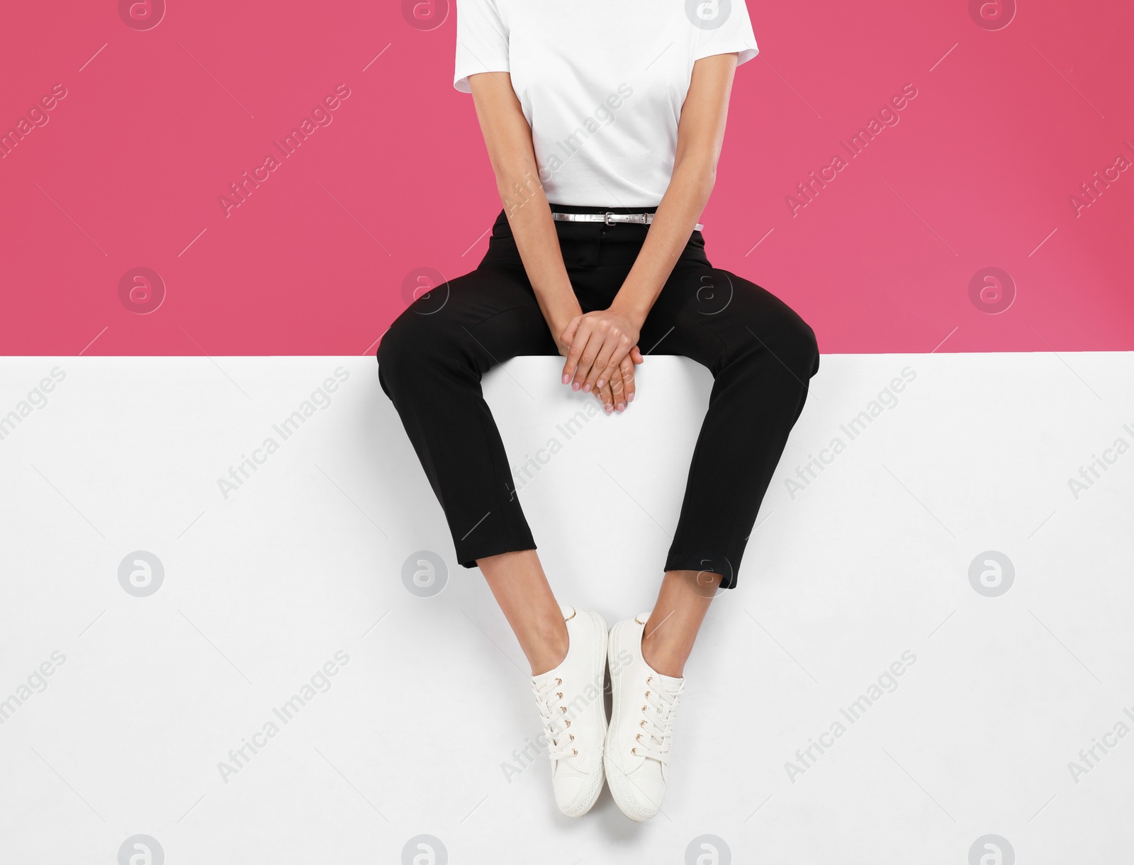 Photo of Woman wearing stylish shoes on color background, closeup