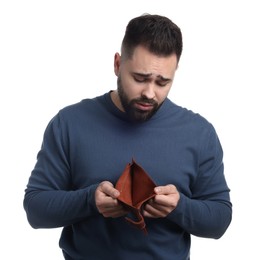 Photo of Upset man showing empty wallet on white background