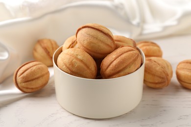 Delicious nut shaped cookies on white wooden table, closeup