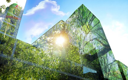 Image of Double exposure of green trees on sunny day and buildings in city