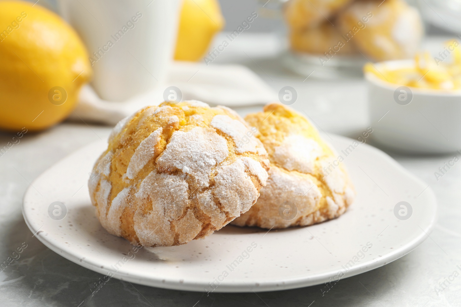 Photo of Plate with delicious lemon cookies on table, closeup