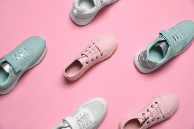 Photo of Different stylish sports shoes on pink background, flat lay