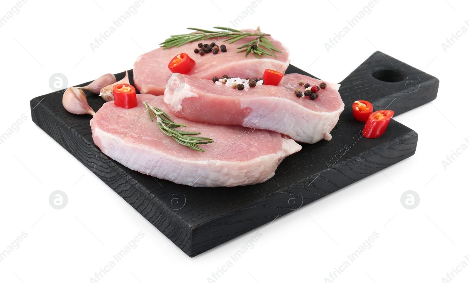 Photo of Black wooden board with pieces of raw pork meat and spices isolated on white