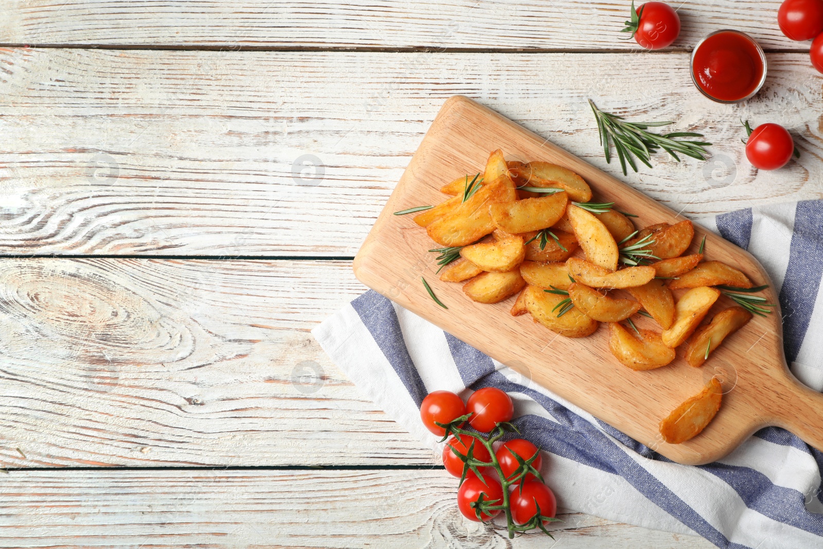 Photo of Flat lay composition with baked potatoes, rosemary and tomatoes on wooden background. Space for text