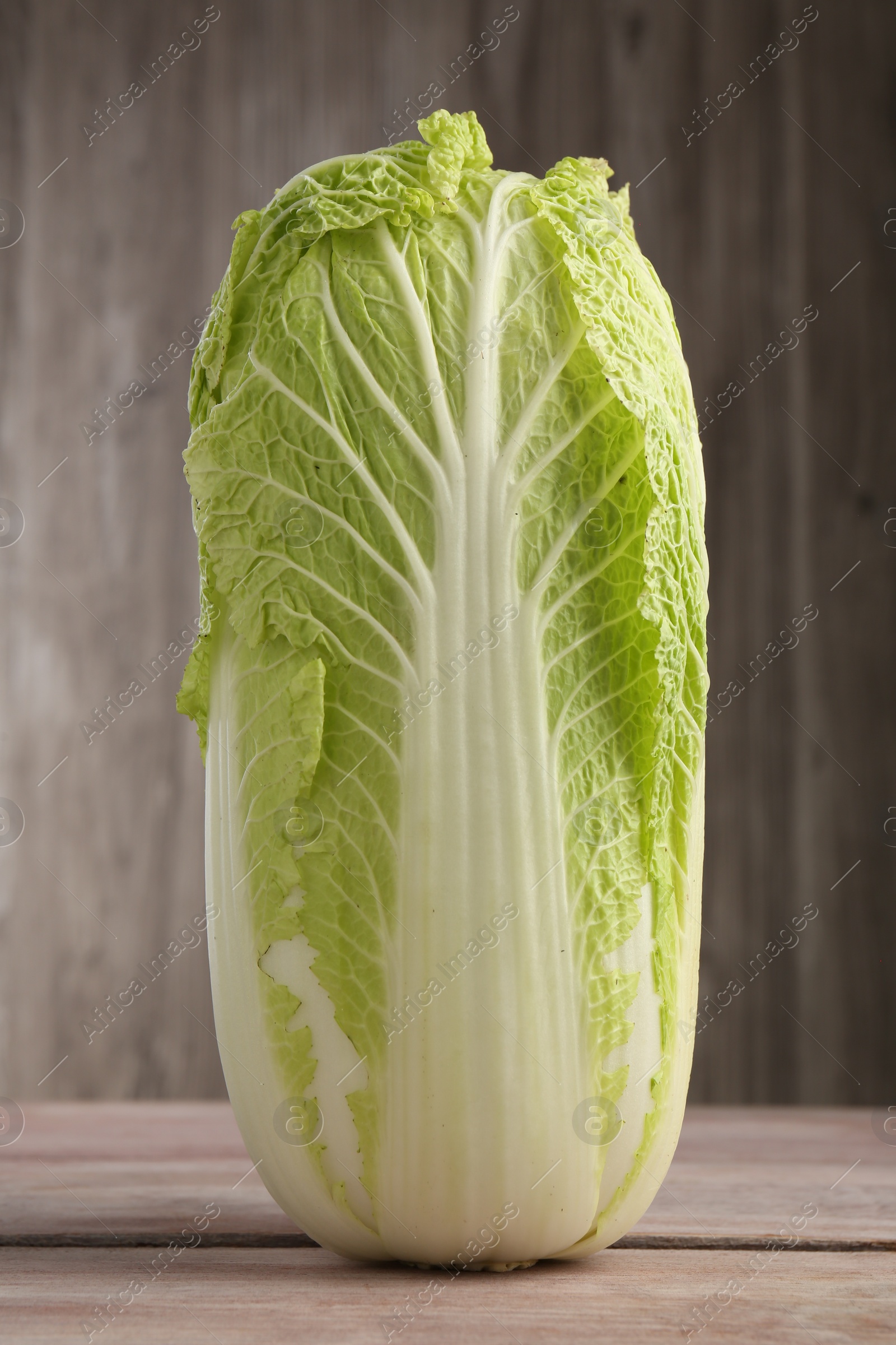 Photo of Fresh ripe Chinese cabbage on wooden table