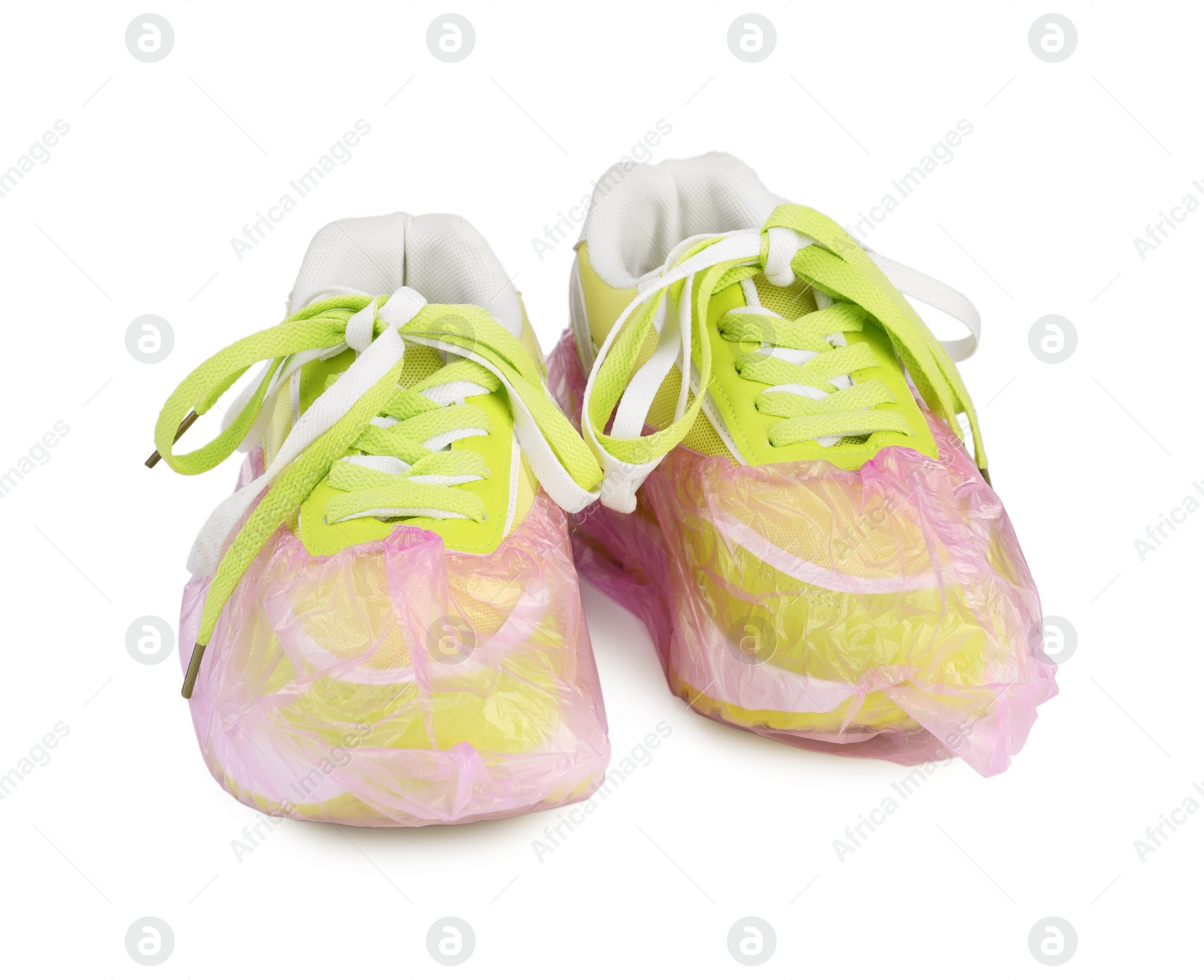 Photo of Sneakers in pink shoe covers isolated on white