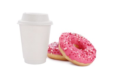 Tasty fresh donuts with sprinkles and hot drink isolated on white